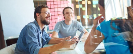 Colleagues working behind glass with post-its