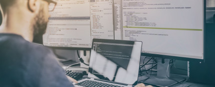 Software Engineer working at desktop computer