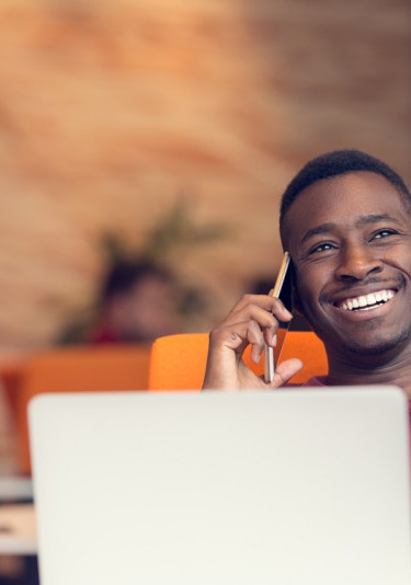Colleague smiling and chatting on mobile phone
