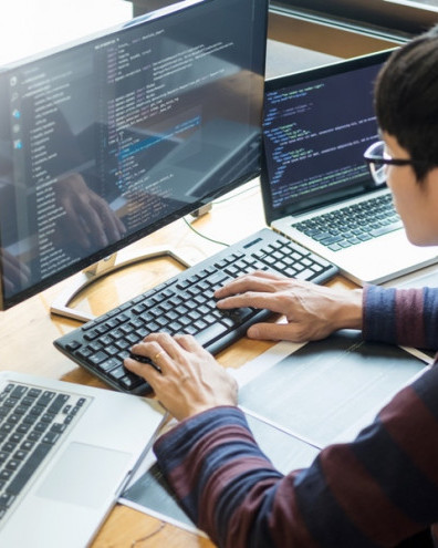 Software Engineer working with multiple screens